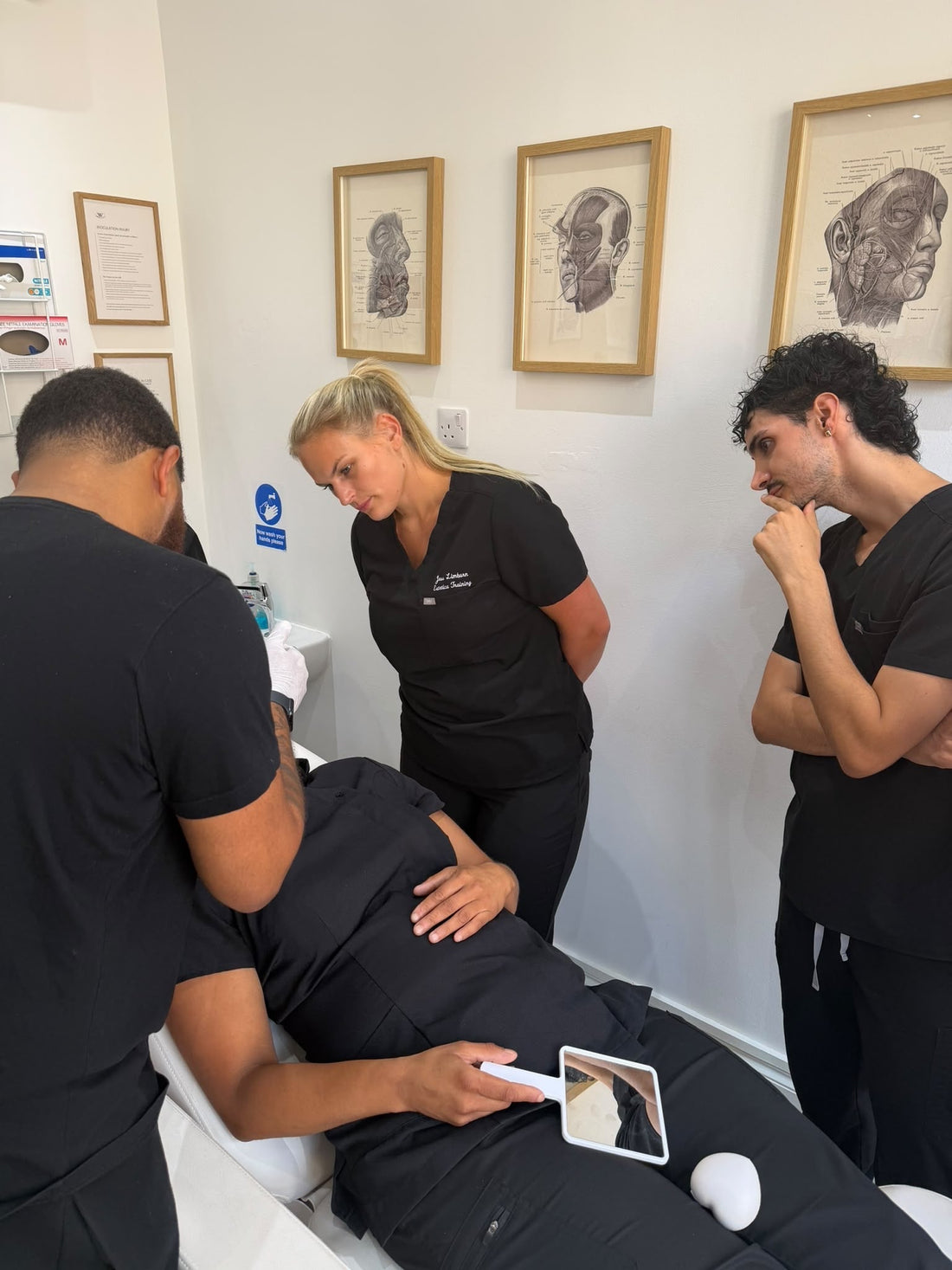 Trainer teaching students for the fast track non medic course at estetica training academy.